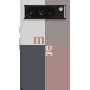 May include: A phone case with a geometric design in shades of gray, white, and pink. The case has a camera cutout and the letters "mg" printed on it.