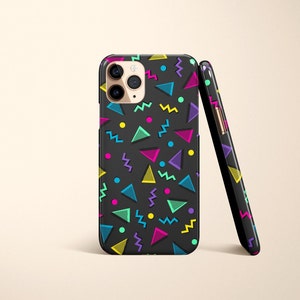 May include: Black smartphone case with a colorful 80s-inspired geometric pattern. The design features triangles, zigzags, and dots in neon colors like pink, yellow, blue, and green. The case is shown upright and leaning against another case.