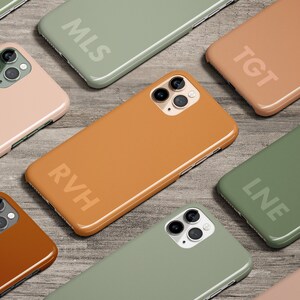 May include: Nine different colored phone cases with initials on each. The cases are in shades of green, brown, and pink.