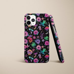 May include: A black phone case with a colorful pattern of mushrooms, flowers, and frogs on a dark background. The case has a cutout for the camera lens.