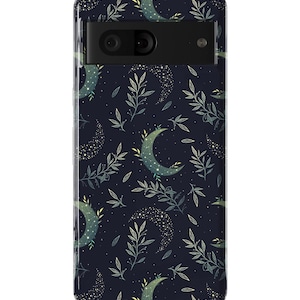 May include: A dark blue phone case with a pattern of white crescent moons, green leaves, and gold glitter.