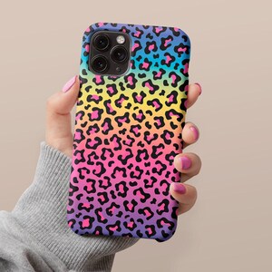May include: A rainbow leopard print phone case for an iPhone. The case has a black background with a rainbow gradient of pink, yellow, blue, and green leopard spots.
