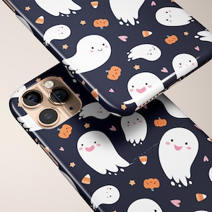 May include: Two iPhone cases with a Halloween theme. The cases are black with a pattern of white ghosts, orange pumpkins, pink hearts, and yellow stars. The cases are shown from different angles.