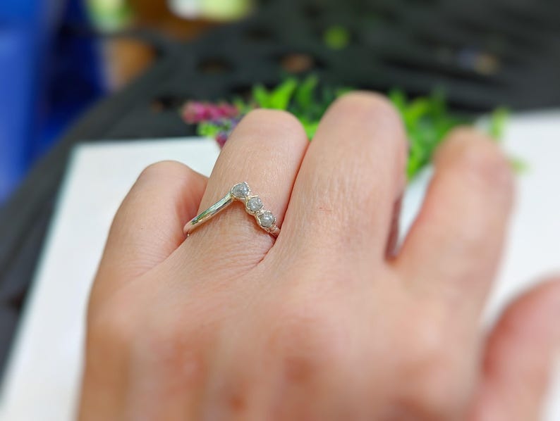 A rough diamond Chevron bridal ring in 18k Gold on a womans hand