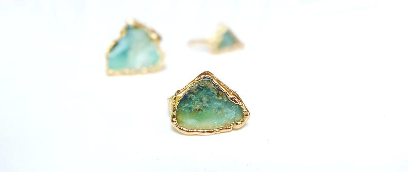 A Solid 14k Gold ring featuring a large raw and uncut Aqua blue Peruvian Opal