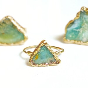 A Solid 14k Gold ring featuring a large raw and uncut Aqua blue Peruvian Opal