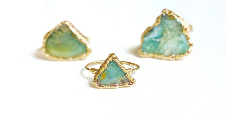 A Solid 14k Gold ring featuring a large raw and uncut Aqua blue Peruvian Opal