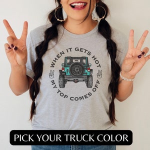 May include: Gray t-shirt with a graphic of a teal Jeep with the text "When it gets hot my top comes off".
