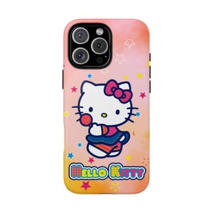 May include: A phone case featuring Hello Kitty. The case has a pink and orange gradient background with star accents. Hello Kitty is depicted holding a lollipop, wearing a pink bow and a blue skirt. The words "Hello Kitty" are at the bottom.