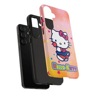 May include: A black smartphone with a black case and a pink and yellow phone case featuring a Hello Kitty design. The Hello Kitty case has a cartoon image of Hello Kitty with a bow and the words "Hello Kitty".
