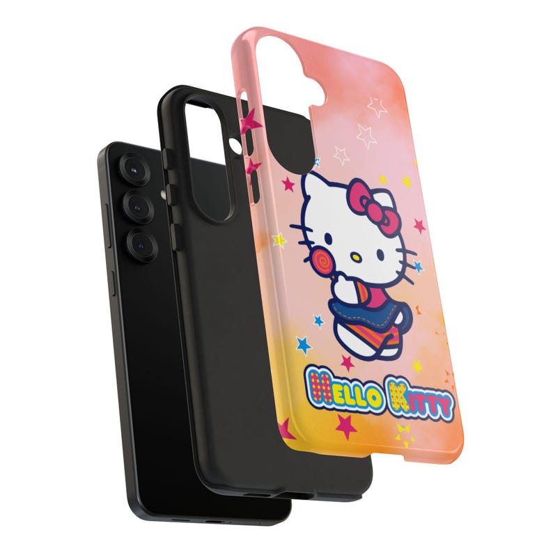 May include: A black smartphone with a black case and a pink and yellow phone case featuring a Hello Kitty design. The Hello Kitty case has a cartoon image of Hello Kitty with a bow and the words "Hello Kitty".