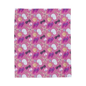 May include: A pink blanket with a repeating pattern of beach-themed elements. The design includes sunglasses, flip-flops, seashells, starfish, and white towels. The flip-flops are pink and blue, and the sunglasses are black.