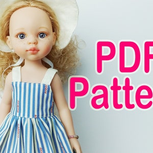 May include: A PDF pattern for a doll dress. The dress is blue and white striped with red accents. The doll is wearing a white hat and has blonde curly hair.