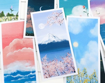 May include: A collection of rectangular art prints featuring landscape paintings. The prints depict various scenes, including a mountain with cherry blossoms, a sunset with clouds, and a night sky with a crescent moon. The color palette includes blues, pinks, and yellows.