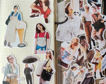 May include: A collection of colorful stickers featuring illustrations of people wearing various outfits. The stickers are printed on white paper and have a glossy finish.