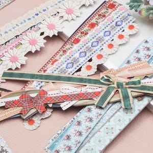May include: A selection of decorative ribbons and trims in various patterns and colours. Includes floral, plaid, and patterned designs with scalloped edges and bow accents. Ideal for crafts and embellishments.