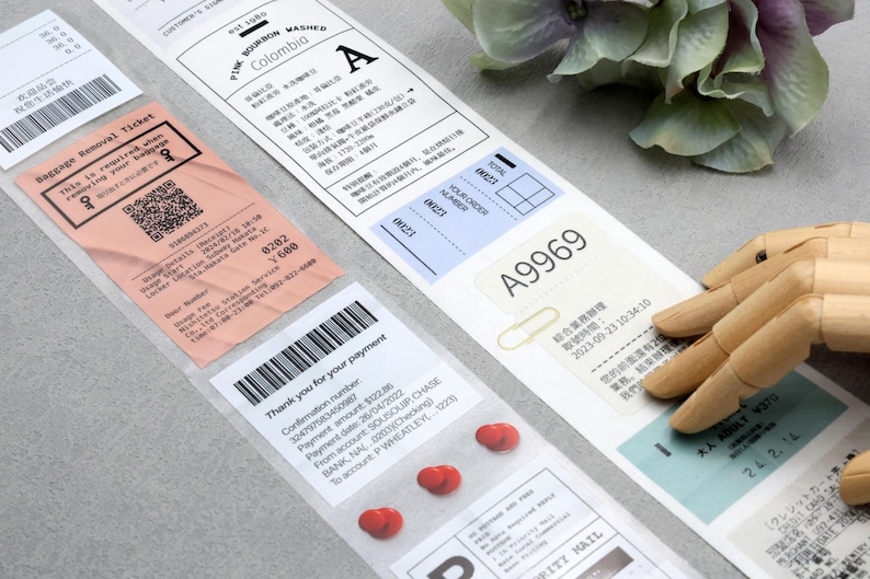 May include: A close-up of various labels and stickers, including a pink baggage removal ticket with a QR code, a white label with the text "PINE BOURBON WASHED Colombia A", a blue label with the text "A9969", and a white label with a barcode and the text "Thank you for your payment".