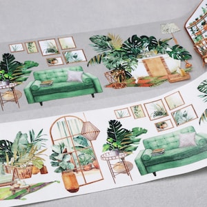 May include: Decorative washi tape featuring a repeating pattern of interior scenes. The design includes green sofas, potted plants, framed artwork, and architectural elements like windows and lamps. The tape is on a gray background.