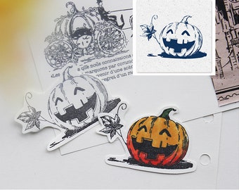 May include: Halloween-themed stickers featuring a smiling jack-o'-lantern with a carved face. One sticker is colored orange and red, while another is black and white. The stickers have a leaf and vine design and are on a white background.
