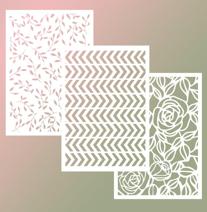 May include: Three white paper cut-out designs on a gradient background. The designs are a floral pattern, a chevron pattern, and a rose pattern.