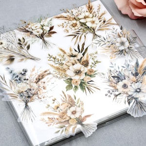 May include: A collection of floral stickers featuring watercolor bouquets in neutral tones. The stickers showcase various arrangements of dried flowers, pampas grass, and other botanical elements, perfect for scrapbooking and crafting projects.