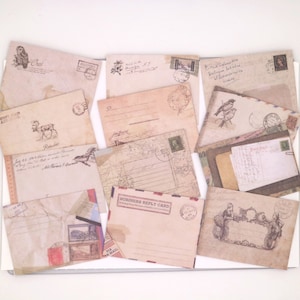 May include: A collection of vintage-style envelopes with various designs, including a reindeer, a bird, and a floral pattern. The envelopes are made of brown paper with a distressed look and have a rustic feel.