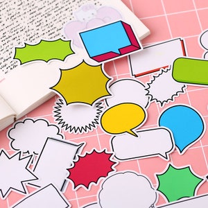 May include: A set of colorful speech bubble stickers with black outlines. The stickers are in various shapes, including circles, stars, and clouds. Some of the stickers have a speech bubble tail.