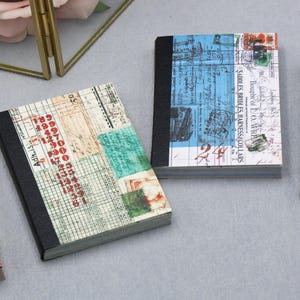 May include: A set of rectangular paper pads featuring vintage-style ledger and document prints. Each pad has a black spine and displays various grids, red numerical data, and blue or beige paper textures with printed text like JUNK JOURNAL.