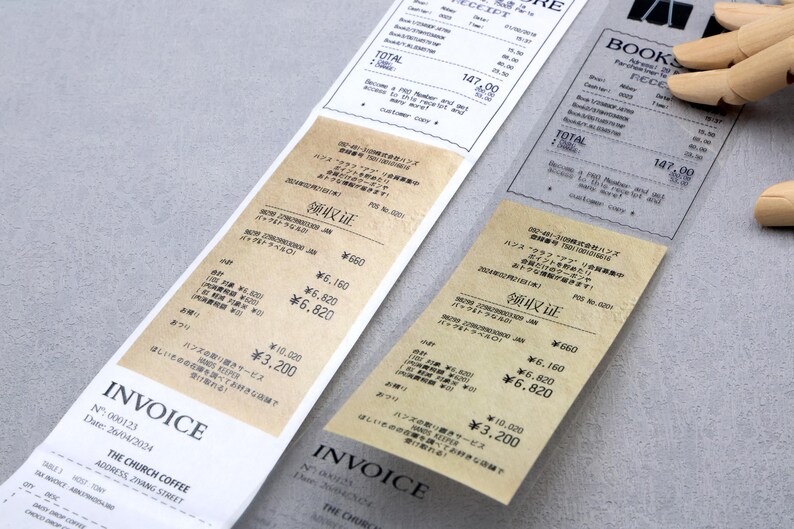May include: Two vintage-style receipts with the text "Invoice" and "领取证" printed on them. The receipts are on a light gray surface. The text on the receipts is in Japanese and English.