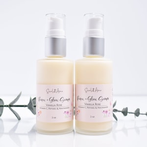 May include: Two 2-ounce bottles of serum labeled "Renew + Glow Serum" in a white and pink font. The bottles are clear and contain a white liquid. The label also says "Vanilla Rose" and lists ingredients including Vitamin C, Peptides, and Niacinamide.
