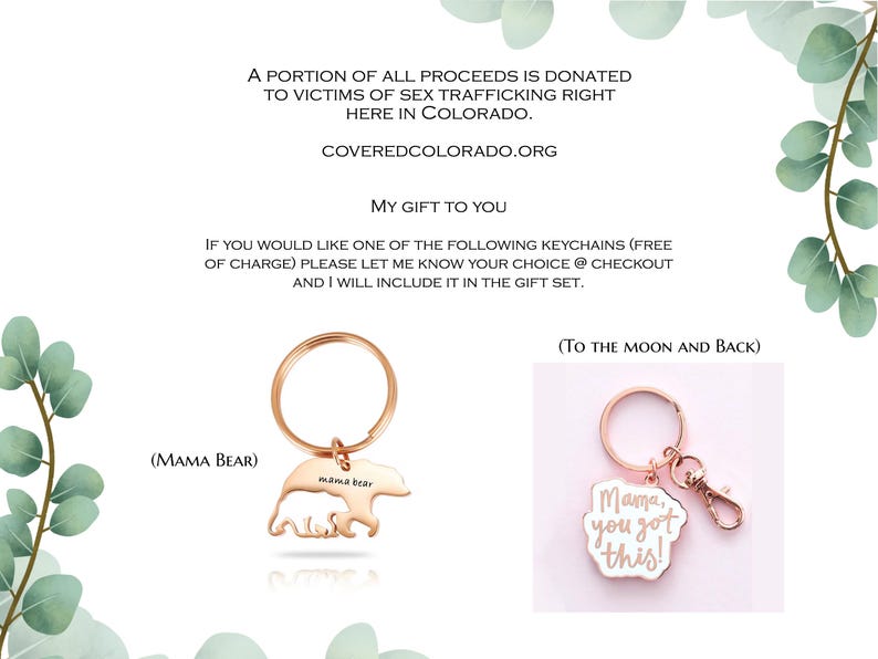 May include: Two rose gold-toned metal keychains. One features a bear silhouette with the text 'Mama Bear' and the other is a scalloped-edge charm with the text 'Mama, you got this!' and a lobster clasp. The image includes text about donations.