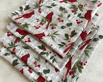 Set of Four Napkins Featuring Red Cardinals on Music Paper Motif.