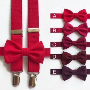May include: A red bow tie and matching braces set with silver-coloured clasps. The image also displays a selection of bow ties in shades of red and burgundy, labelled A to E.