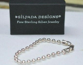 May include: A silver chain bracelet with a clasp. The bracelet is made of small, round beads. The bracelet is in a black box with the text "Silpada Designs® Fine Sterling Silver Jewelry".