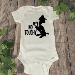 May include: White baby onesie with a black silhouette of a cartoon dog with the text "NO TOUCHY" printed on the front.