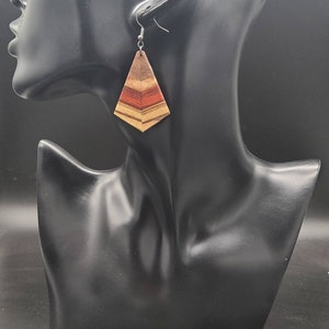 Wooden dangle earrings, lightweight, handmade, and multi colored, fancy or casual, able to be worn anytime, has silver hooks