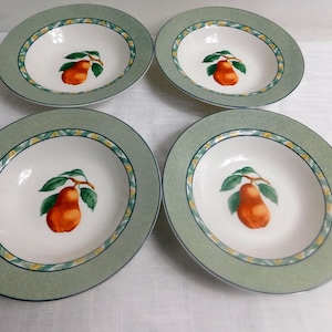 May include: A set of four round ceramic soup bowls featuring a white center with a single orange pear illustration, surrounded by a wide sage green rim with a decorative border of yellow and blue accents along the inner edge of the rim.