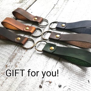 Six leather keychains, green, brown, dark. town, blue, black color. Text" Gift for you"!