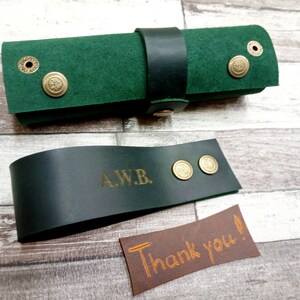 Folded green tobacco tray and pipe stand.