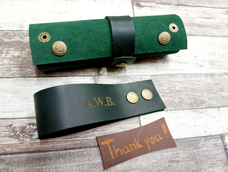 Folded green tobacco tray and pipe stand.