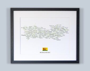 Könnte beinhalten: Ein schwarzer gerahmter Druck einer Karte von Berkshire, England. Die Karte besteht aus den Namen der Städte und Gemeinden des Countys, wobei die Namen so angeordnet sind, dass sie die Form des Countys bilden. Die Karte hat einen weißen Hintergrund und die Namen sind in grüner Schrift. Der Druck enthält auch das Wappen des Countys, ein gelbes Schild mit einem roten Löwen.