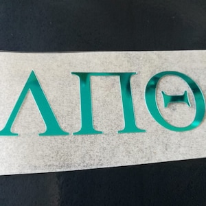 May include: A teal green vinyl decal with the Greek letters "ΑΠΘ" for Alpha Pi Theta.