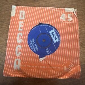 May include: A vintage 45 RPM vinyl record in an orange and white striped Decca paper sleeve. The blue center label features the text Mouldy Old Dough by Lieutenant Pigeon, with the Decca logo, 1972 date, and catalog number F.13278 printed clearly.