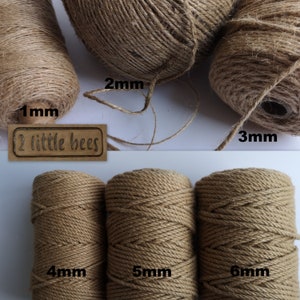 May include: Six spools of natural jute twine in various sizes, from 1 mm to 6 mm. The spools are labelled with the twine thickness in millimetres. The brand name "2 little bees" is printed on a brown label.