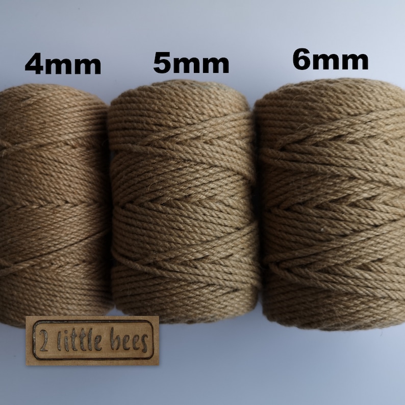 May include: Three spools of natural brown cotton rope, each with a different thickness: 4mm, 5mm, and 6mm. The spools are labeled with the thickness in millimeters. The spools are sitting on a white surface. The label "2 little bees" is visible in the bottom left corner of the image.