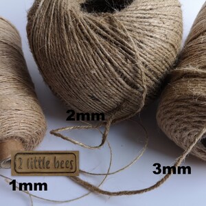 May include: Three spools of natural brown twine, labeled 1mm, 2mm, and 3mm. The spools are made of natural jute fiber and are perfect for crafting, wrapping, and decorating.