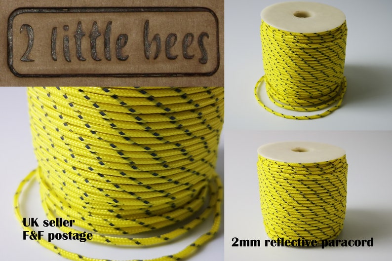 May include: A spool of 2mm yellow reflective paracord with black diamond-shaped stripes. The paracord is wound around a white cardboard core. The text "2mm reflective paracord" is printed below the spool.