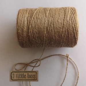 May include: A roll of natural brown twine with a label that reads "2 little bees".