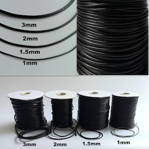 May include: Four spools of black waxed cotton cord in different sizes: 1 mm, 1.5 mm, 2 mm, and 3 mm. The cord is wound around white spools.
