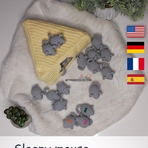 May include: A crochet memory game featuring a yellow triangle pouch and gray crocheted mice. The game is called "Sleepy Mouse - Memory Game" and is designed by Alina Hoza.